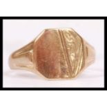 A 9ct hallmarked gold signet ring having an armorial shield shaped front with no inscription and