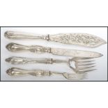 A group of four large hallmarked silver salad servers / serving cutlery to include a Georgian