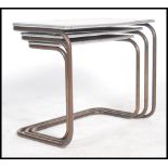 A trio nest of counter lever tables of tubular met