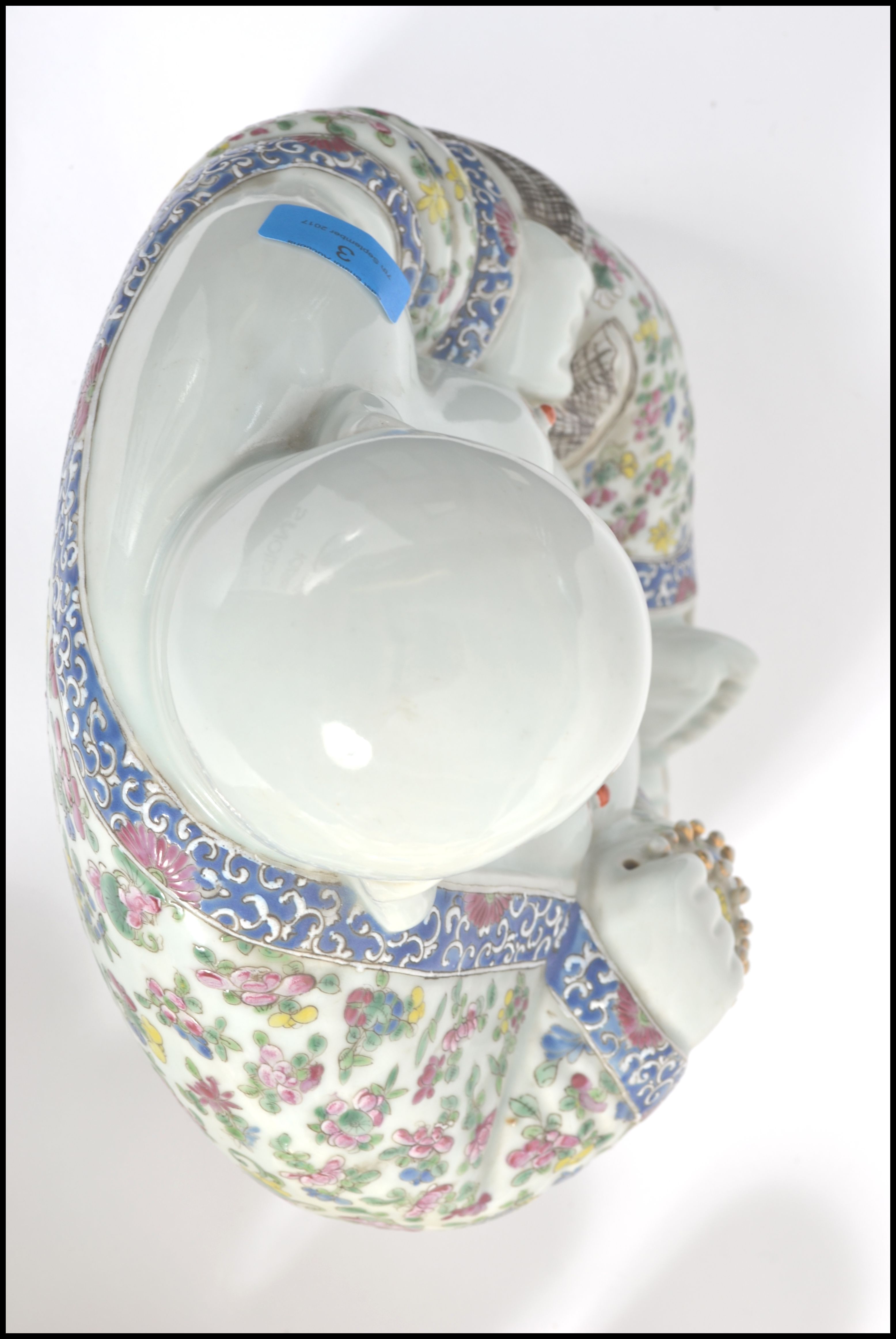 An Oriental ceramic large seated laughing Buddha decorated in famille rose patterned robes holding - Image 8 of 8