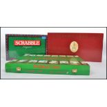 A Centenary Peter Rabbit race game in original red box along with a sealed 1980s Scrabble game and a