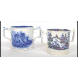 A pair of 19th century Staffordshire blue and white twin handled loving cups, each with country