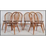 A set of six Ercol spindle back dining chairs on tapered legs in the blonde colourway. Measures