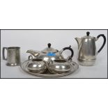 A retro Tudoric style pewter made tea service by Hall Brothers, including the tray, teapot etc.