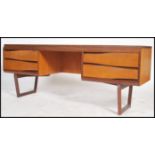 A retro teak wood White and Newton desk, raised on