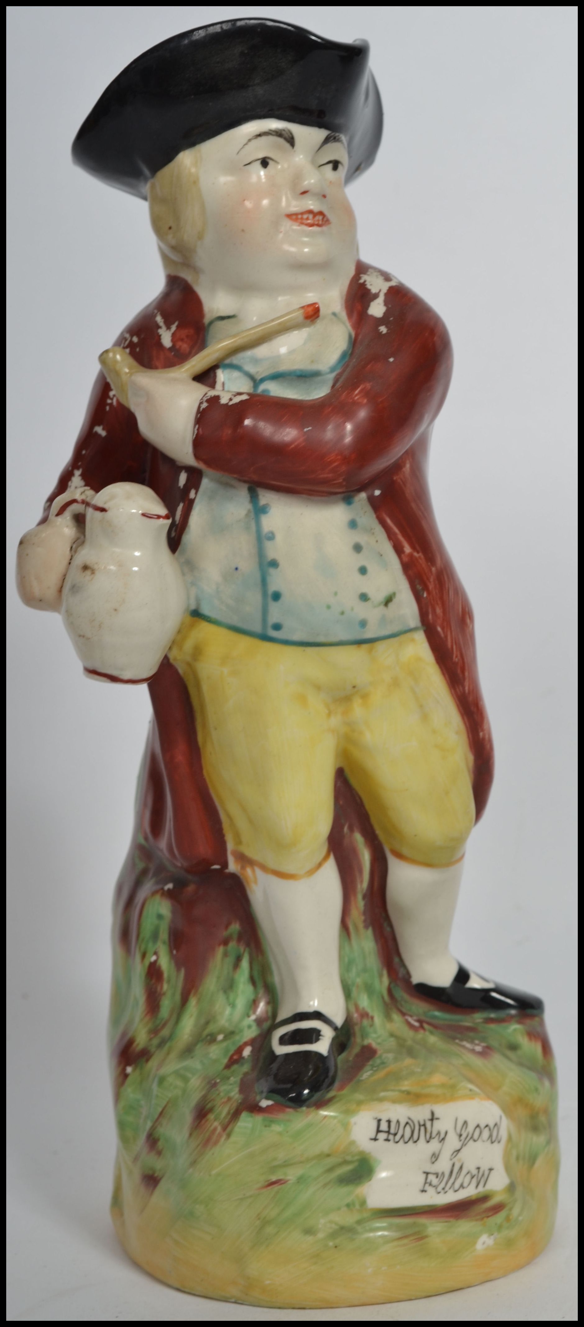 An early 19th century Pratt - type Staffordshire Toby jug of a man in a tricorn hat with pipe and