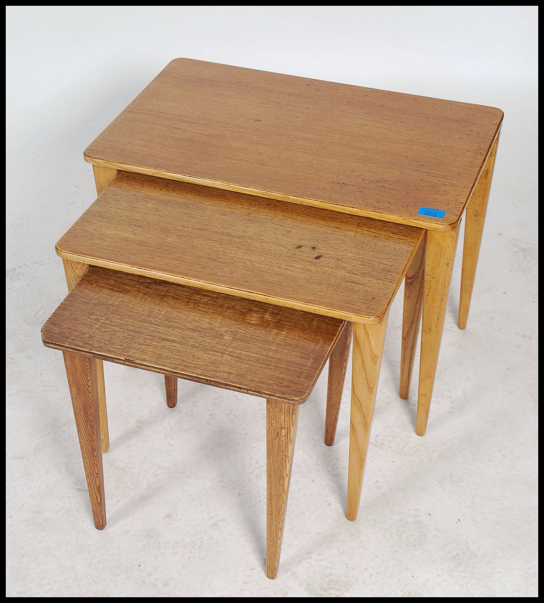 A vintage 20th century retro trio nest of tables with panel tops raised on square tapering legs with - Image 4 of 5