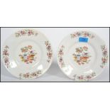 A pair of 19th century English Chinoiserie cabinet plates, each with stylised borders and central