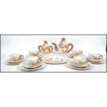An Oriental ceramic six person tea service decorated with chasing dragons comprising of six cups,