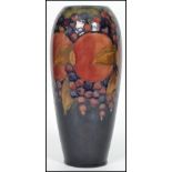 An early 20th century William Moorcroft hand painted ceramic tubelined vase decorated in the