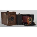 Early 20th century Ensign box camera together with a Kodak Brownie red leather bellows camera.