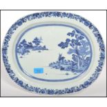 An early 19th century circa 1810 Chinese blue and white ceramic charger depicting a house to the