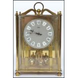 A 20th century glass cased mantle clock with columned front faceted hands and a roman numeral