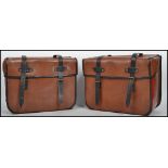 A pair of vintage 20th century side saddle bike panniers of leather construction. Measurements: 26