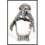 A contemporary and unusual 20th century silver novelty figure of a penguin having glass eyes