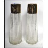 A pair of early 20th century silver plated and dimple glass Claret jugs, the glass bodies of