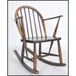 A mid 20th century Ercol rocking chair having cc utility mark raised on box rockers with rail