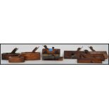 A collection of vintage woodworking planes to include a plough plane, coffin planes, and wooden