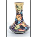 A 20th century Moorcroft tubelined baluster vase having an ovoid body with tapering neck and