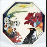 A Moorcroft Designers Medley octagonal plate, tube lined with bird, butterfly and stylised