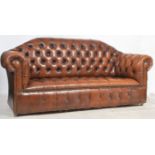 An antique style Chesterfield sofa settee in tan brown leather being button back to the seat and