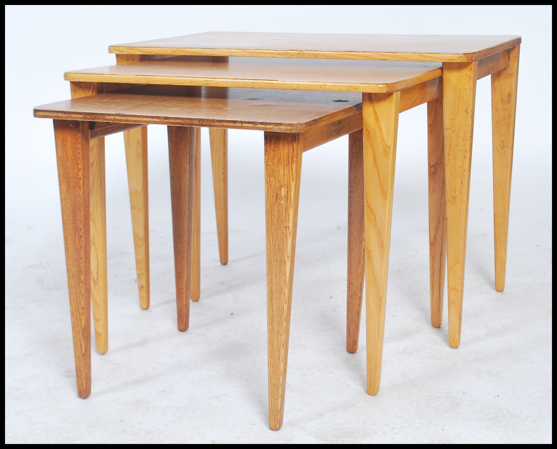 A vintage 20th century retro trio nest of tables with panel tops raised on square tapering legs with - Image 3 of 5