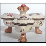 A 19th century Continental Majolica table cruet / salts, raised on tripod pad paw feet with lidded