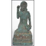 A 19th century Oriental bronze figure of a Buddha moulded in a kneeling position with jar to hand