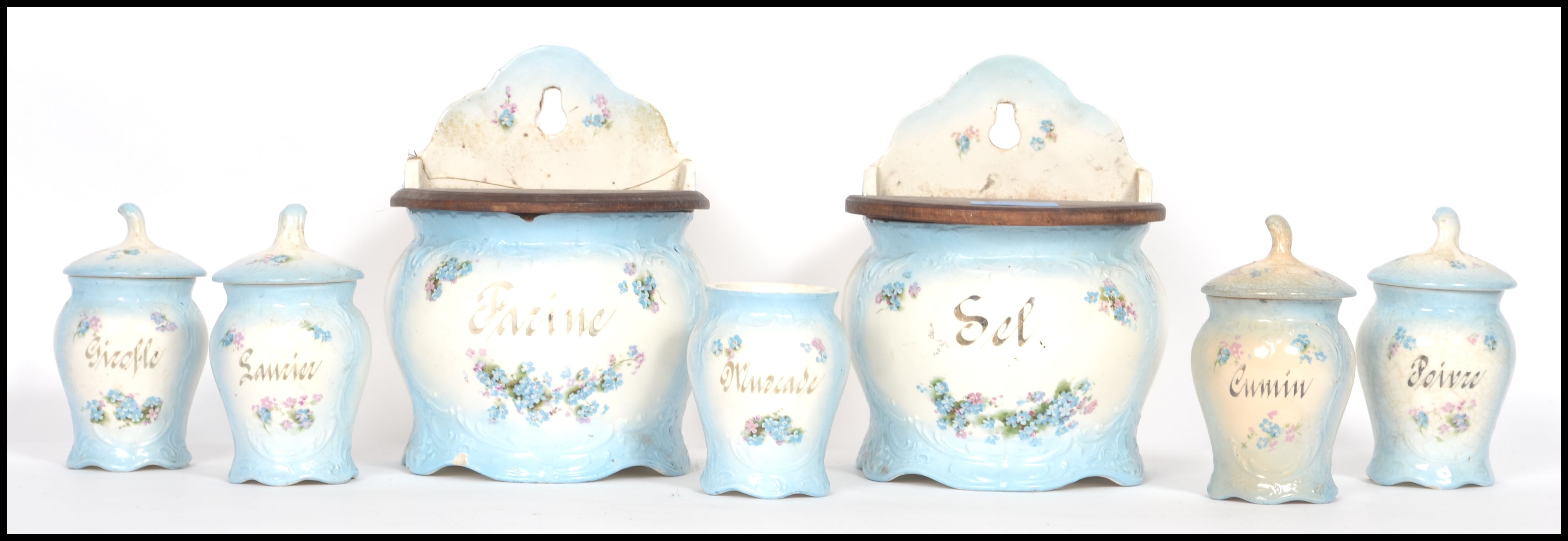 A set of 7 19th century French kitchen canisters to include two wall mounted with wooden lids