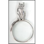 A contemporary decorative ladies silver necklace pendant in the form of a magnifying glass having