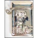 A silver white metal match Vesta having a mermaid in relief to the front, hinged top opening.