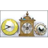 A Majik Russian crystal clock along with a Metamec yellow and chrome circular clock and a brass