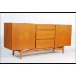 A 1950's Post Modernist teak wood sideboard having central bank of blind front drawers with