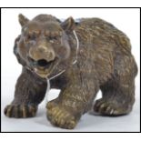 A vintage 20th century hollow cast bronze bear with detailed features and open jaw. Measurements: 10