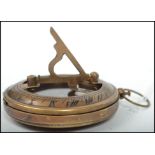 A 20th century brass cased compass of military design bearing notation to the verso together with