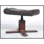 A 1970 Kebe leather footstool / ottoman on a wooden 4 point splayed base. Measures 38cms x 37cms x