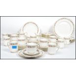 A 20th century Royal Albert dinner and tea service on the Belinda pattern consisting of coffee cans,