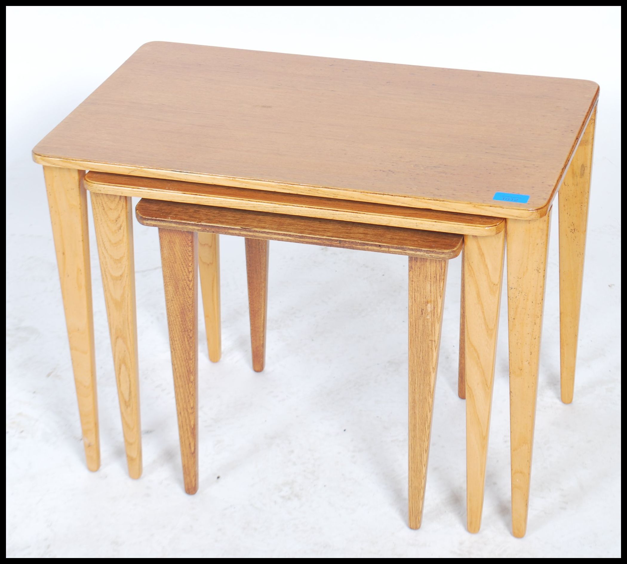 A vintage 20th century retro trio nest of tables with panel tops raised on square tapering legs with - Image 2 of 5