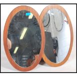 A pair of 1970s teak frameless oval mirrors. Measures 0.5cms x 56cms x 36cms.