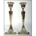 A matching pair of silver hallmarked silver candle sticks but each having different assay marks