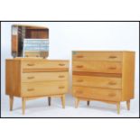 A retro 1970's straight 6 chest of drawers with gilded handles and raised on turned legs together
