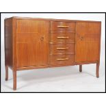 A 1950's mahogany and line inlaid retro sideboard in the manner of Vansen. The sideboard with line