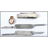 A group of vintage pen knives to include a rococo influence sterling silver example, a believed