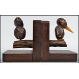 A pair of early 20th century art deco novelty bookends in the form of woodpeckers raised on