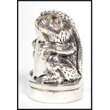 A contemporary novelty silver thimble being in the form of a rabbit complete with a pin cushion (