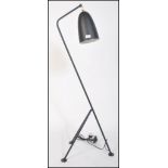 After Greta Grossman, a large black grasshopper floor lamp. Having a tubular steel tripod frame with