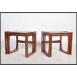 A pair of good 1970's retro G-Plan '  Quadrille ' nest of tables being raised on squared legs with