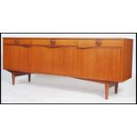 A good 1970's Danish inspired teak sideboard being raised on square tapered legs with a series of