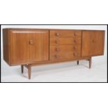 An Ensign pattern elm sideboard by Bristow & Townsend having a series of drawers flanked by