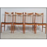 A set of 4 retro 20th century  teak wood spindle backed dining chairs with faux leather black